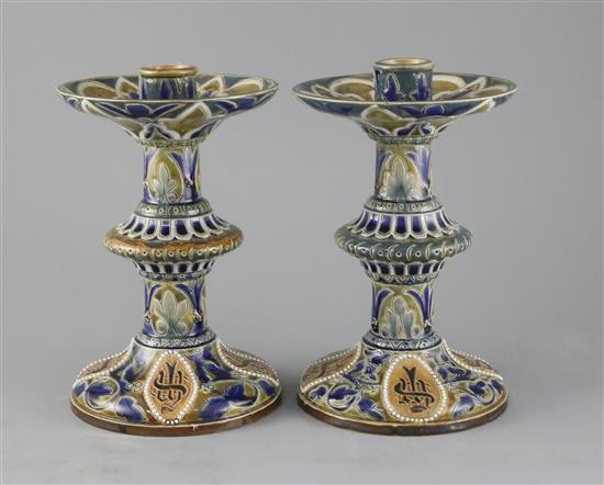 Edith D Lupton for Doulton, a pair of monogrammed candlesticks, dated 1879, H. 22.5cm